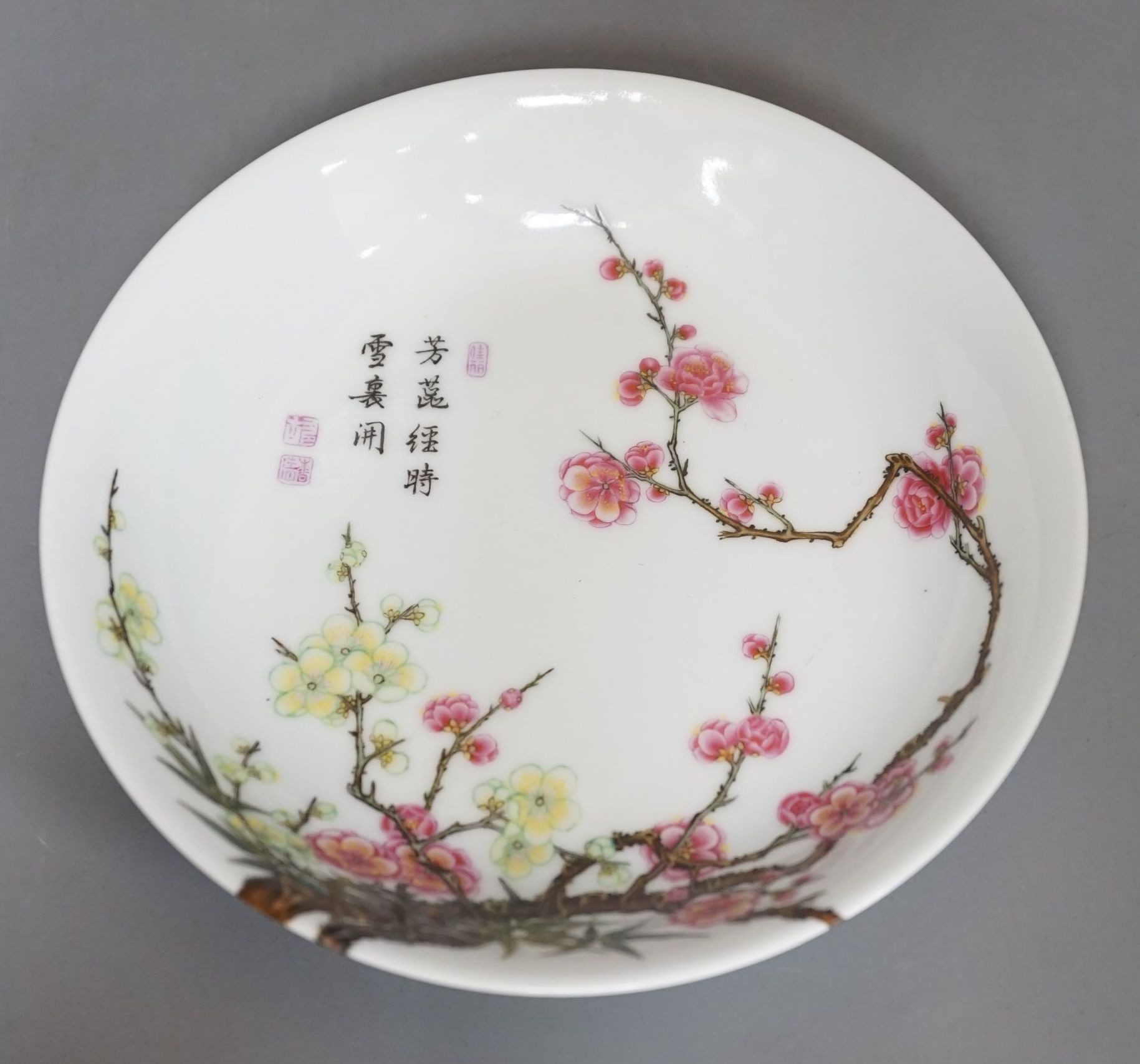 A boxed Chinese famille rose saucer dish, Yongzheng mark, 17 cms diameter.